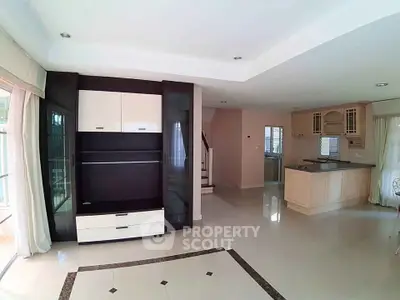 Spacious open-plan living room with modern kitchen and elegant flooring