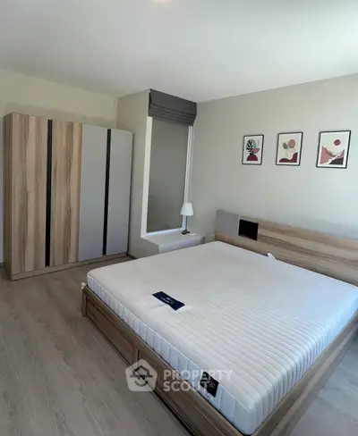 Modern bedroom with stylish decor and large wardrobe in a cozy apartment.