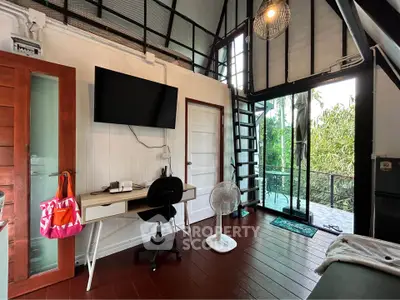 Charming loft-style living room with balcony and modern decor