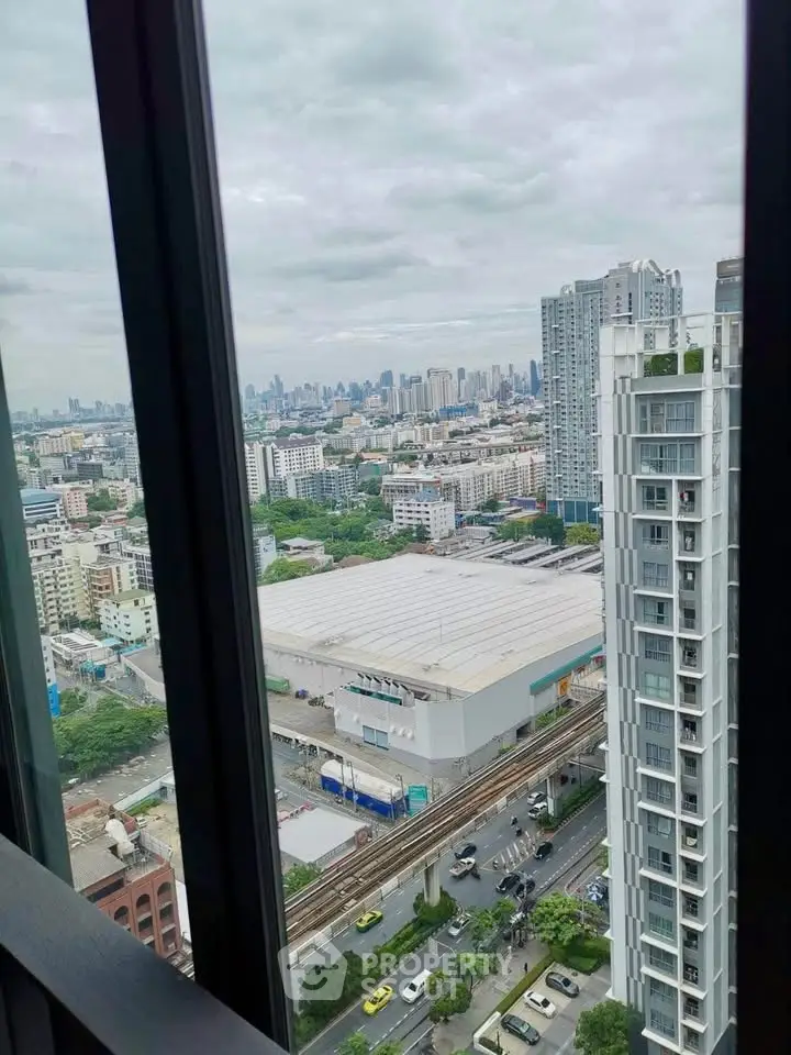 Stunning cityscape view from high-rise apartment window, showcasing urban skyline and bustling streets below.