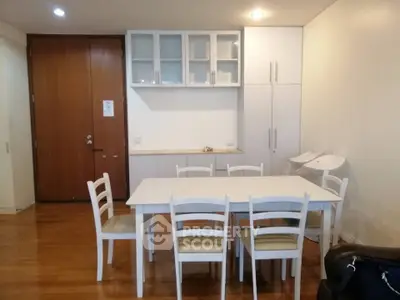 Spacious dining area with modern white furniture and wooden flooring