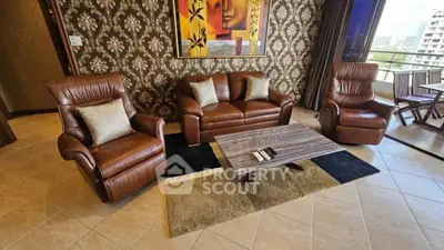 Luxurious living room with leather furniture and city view balcony.