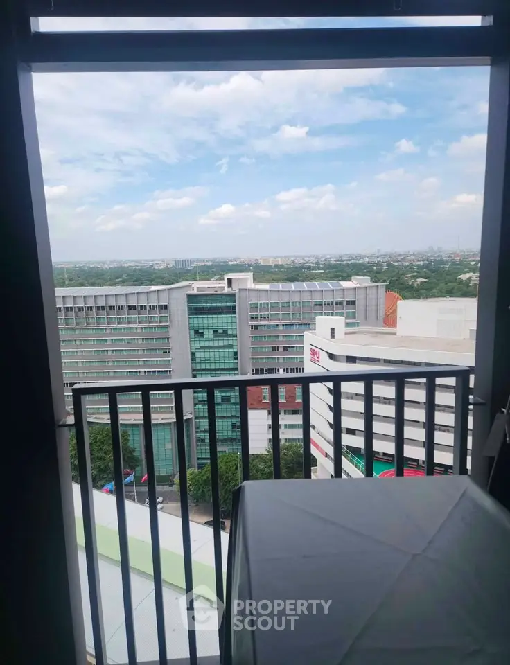 Stunning cityscape view from a high-rise balcony, showcasing modern architecture and expansive skyline.