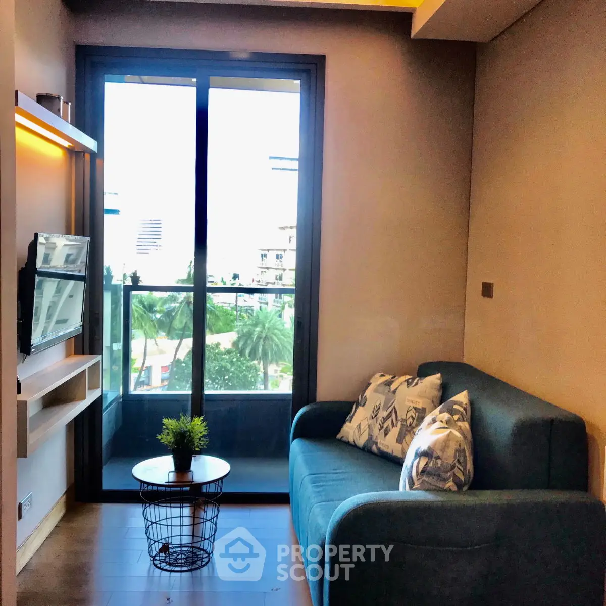 Modern living room with balcony view and stylish sofa in urban apartment.