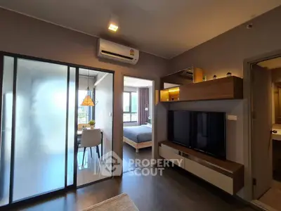 Modern apartment interior with sliding glass doors, cozy living area, and stylish bedroom.