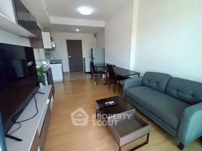Modern living room with sleek furniture and open kitchen layout, perfect for urban living.