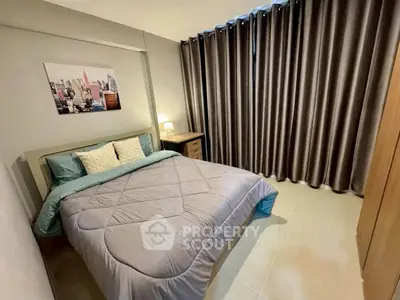 Cozy bedroom with modern decor and cityscape artwork, featuring elegant curtains and ambient lighting.
