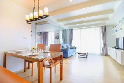 Spacious and bright living room with dining area, modern decor, and large windows for natural light.