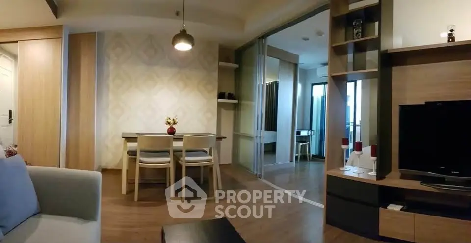 Modern living room with stylish decor and open layout, featuring a cozy dining area and sleek entertainment center.