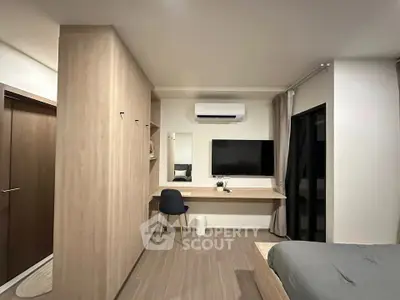 Modern bedroom with built-in wardrobe, desk, and wall-mounted TV