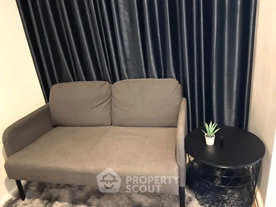 Cozy living room with modern gray sofa and stylish side table