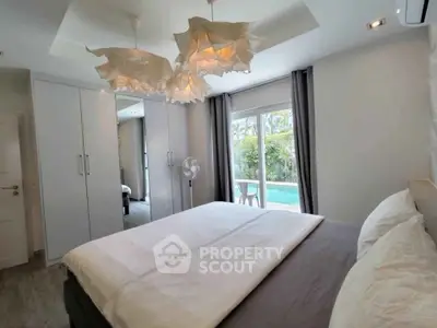 Luxurious bedroom with pool view and elegant lighting