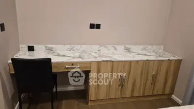 Modern study area with marble countertop and wooden cabinetry