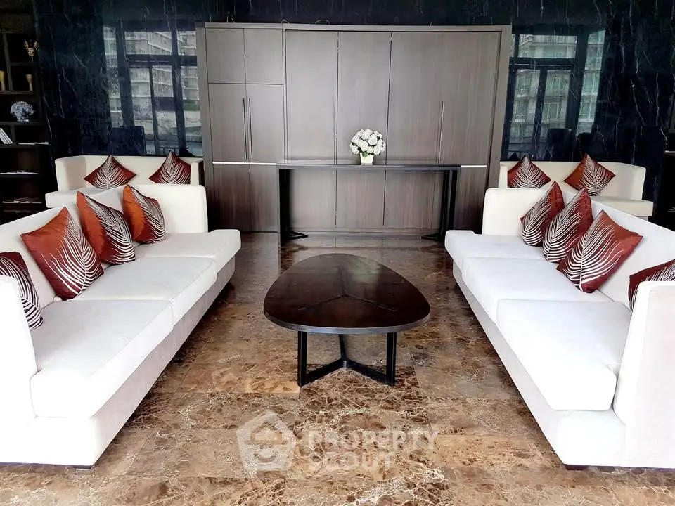 Luxurious living room with elegant sofas and marble flooring in modern apartment.