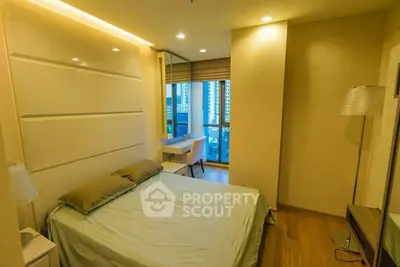 Cozy bedroom with city view and modern decor, featuring a comfortable bed and stylish lighting.