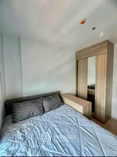 Modern bedroom with sleek wooden wardrobe and cozy bed in a stylish apartment.