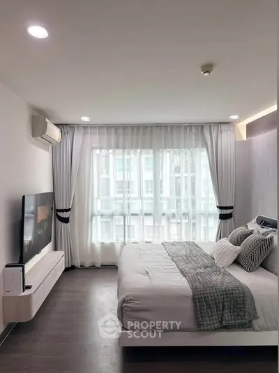 Modern bedroom with large window and stylish decor in urban apartment