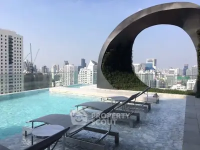 Luxurious rooftop pool with stunning city skyline view and modern architectural design.