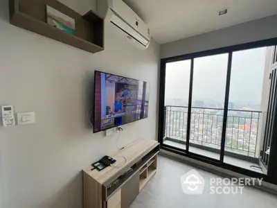 Modern living room with city view and wall-mounted TV in high-rise apartment