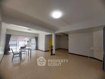 Spacious living room with minimalist decor and large windows for natural light.