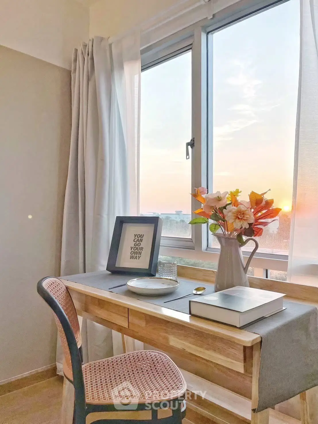Cozy study nook with sunset view, wooden desk, and elegant decor.