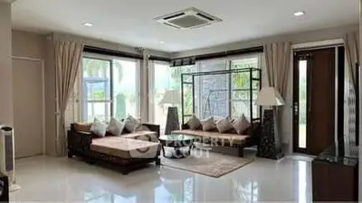 Spacious living room with modern furniture and large windows offering natural light