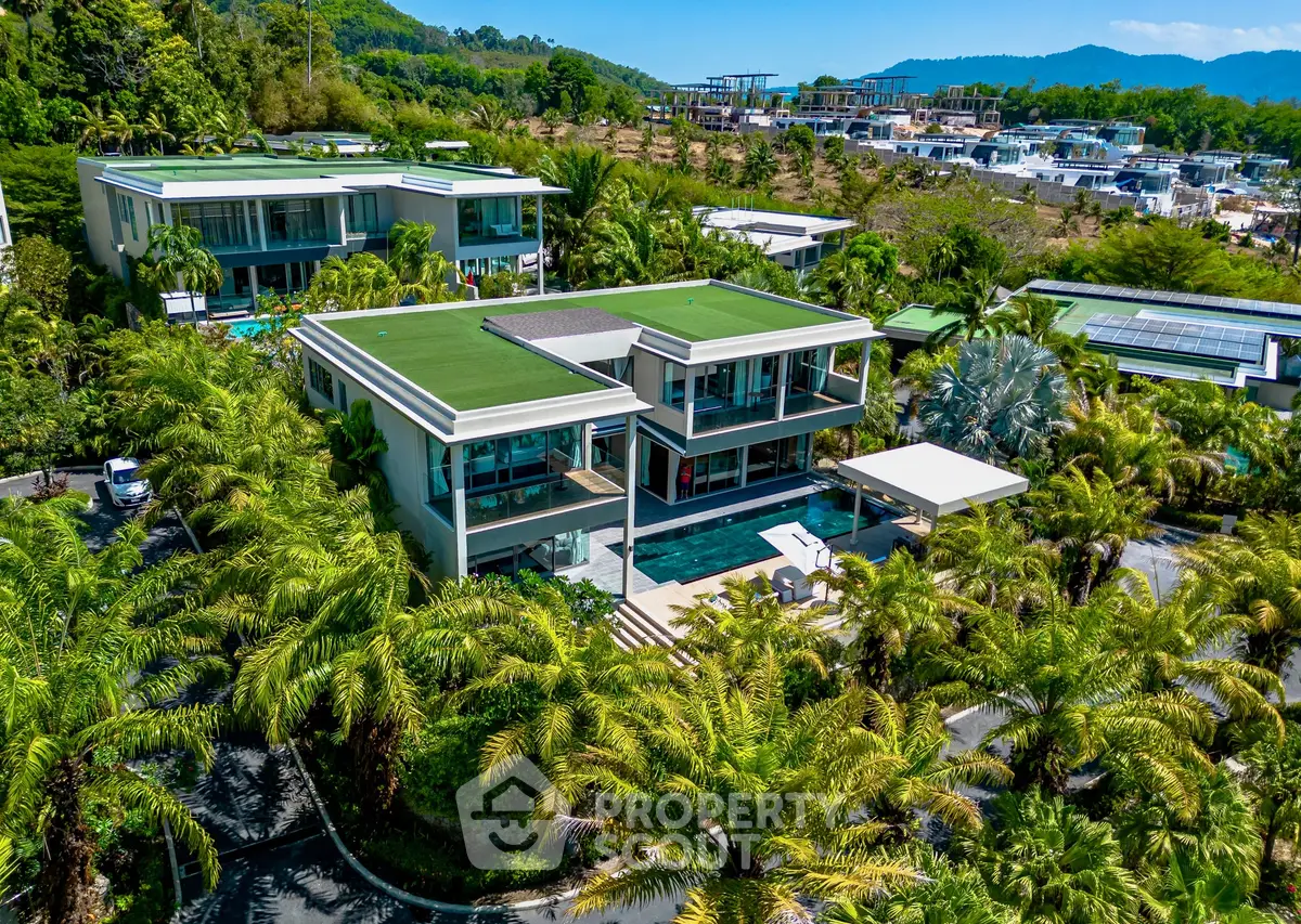 Luxurious modern villa with pool and lush greenery, offering stunning views and privacy.