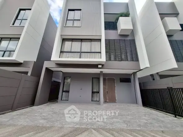 Modern townhouse exterior with sleek design and spacious driveway