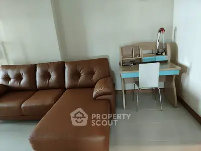 Modern living room with brown leather sofa and compact study desk