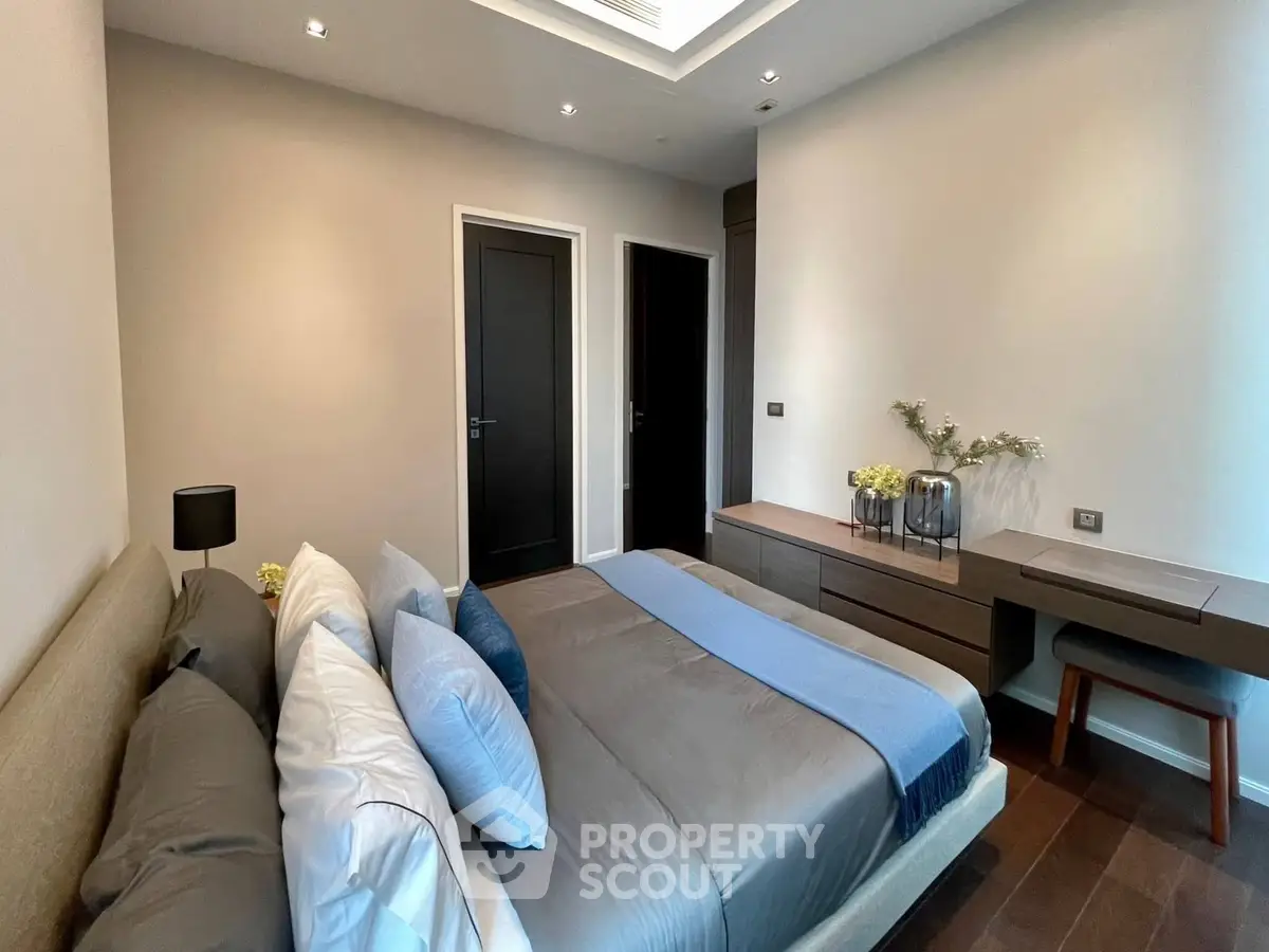 Modern bedroom with elegant decor and cozy ambiance, featuring a stylish bed and sleek furniture.