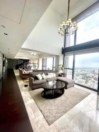 Luxurious high-rise living room with panoramic city views and elegant decor.