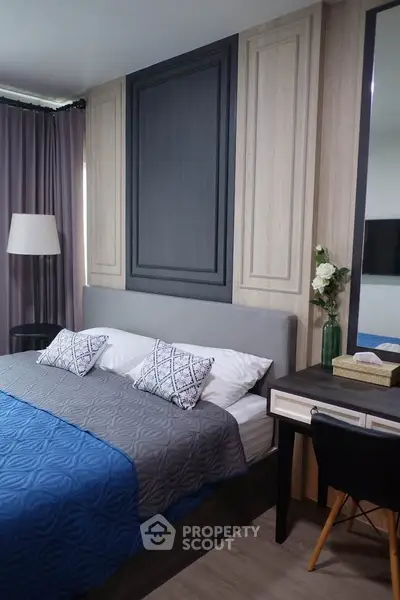 Modern bedroom with stylish decor and cozy ambiance, featuring a comfortable bed and elegant furnishings.