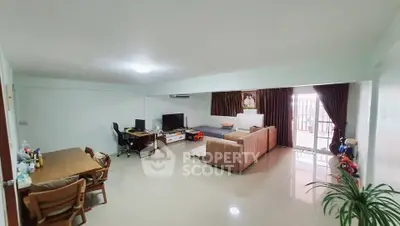 Spacious living room with modern furniture and large windows for natural light.
