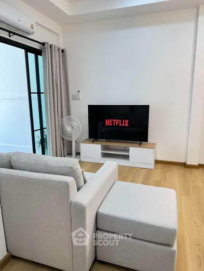 Modern living room with sleek furniture and Netflix-ready TV setup, perfect for relaxation.