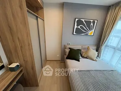 Modern bedroom with stylish decor and large window for natural light