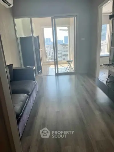 Modern apartment with spacious living room and balcony view.