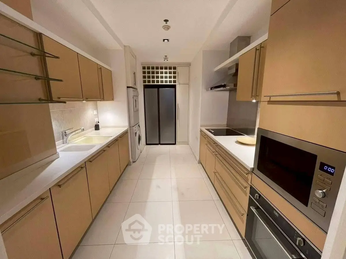 Modern kitchen with sleek cabinetry and built-in appliances in a spacious closed layout.