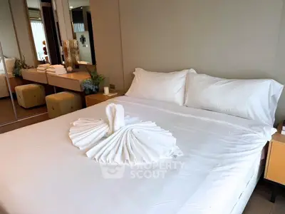 Luxurious bedroom with elegant decor and plush bedding in modern real estate property.