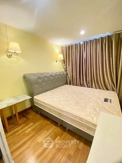 Spacious bedroom with elegant bed and wooden flooring in modern apartment