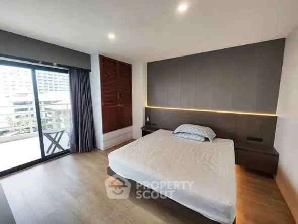 Modern bedroom with balcony access and sleek design in urban apartment