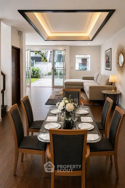 Spacious open-plan living and dining area with elegant decor and garden view.