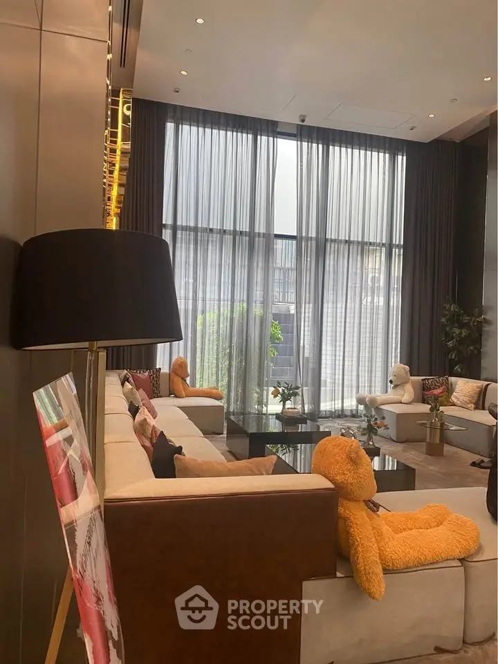 Luxurious living room with plush seating and floor-to-ceiling windows