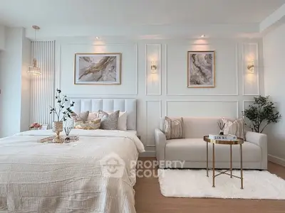 Luxurious bedroom with elegant decor and cozy seating area, perfect for relaxation and comfort.