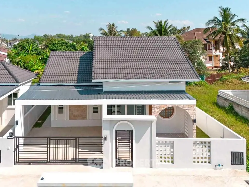 Modern single-family home with sleek design and spacious driveway in a serene neighborhood.