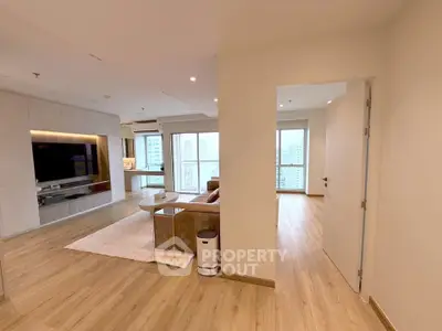 Spacious modern living room with open layout and city view, featuring elegant wooden flooring and stylish decor.