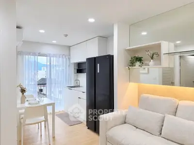 Modern open-layout living room and kitchen with sleek design and natural light
