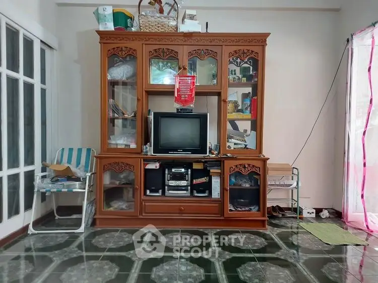Charming living room with vintage wooden cabinet and classic TV setup, perfect for cozy family gatherings.