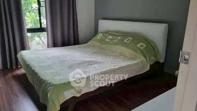 Cozy bedroom with large window and stylish decor