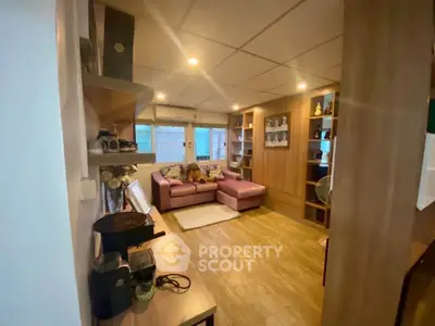 Cozy living room with modern decor and ample natural light, perfect for relaxation and entertainment.