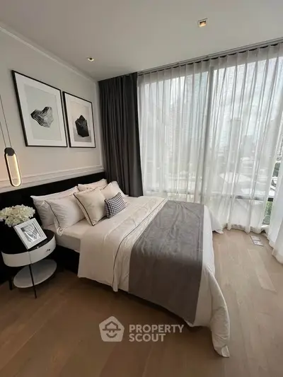 Luxurious bedroom with floor-to-ceiling windows and elegant decor in a modern apartment.